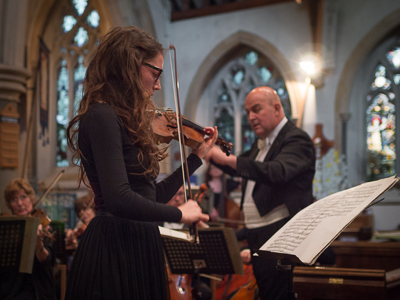 Photo: Eloisa-Fleur Thom playing the Tchaikovsky Violin
        Concerto with the Surrey Philharmonic